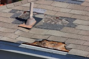 missing shingles, worn shingles, and rotten roof decking